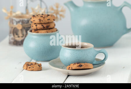 Coffee with chocolate cookies in a blue ceramic cup on the background of Christmas accessories Stock Photo