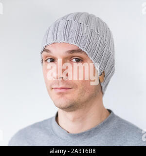 Cool man in winter fashion. Wearing scarf and knit hat Stock Photo