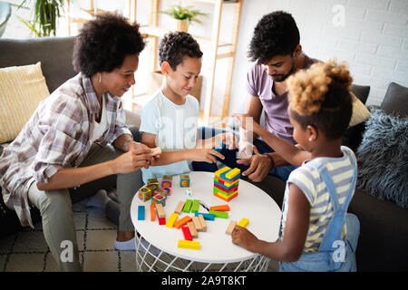 Happy family playing jenga together at home. Stock Photo