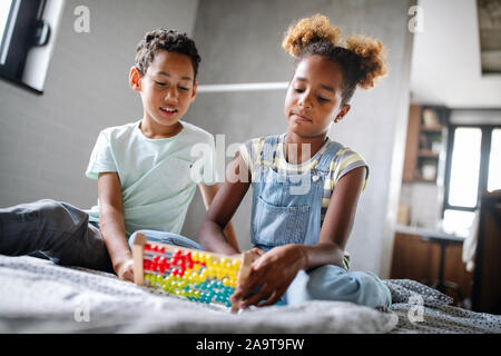 Children, education, plyaing happiness concept. Happy kids entertaining themselves at home Stock Photo