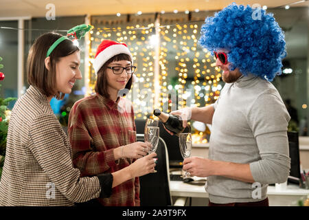 Group of businesspeople celebrating Christmas in office and having champagne Stock Photo