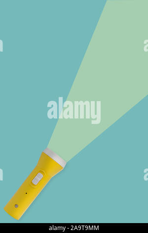 Yellow flashlight on a blue background with copy space. concept of light. Stock Photo