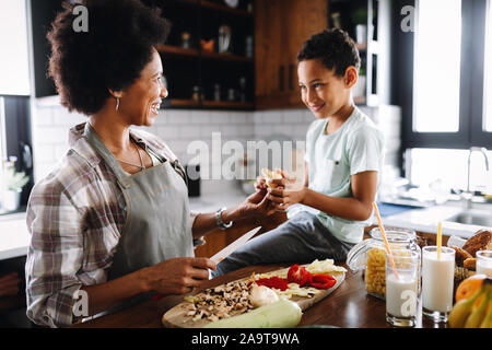 Mother and child having fun preparing healthy food in kitchen Stock Photo