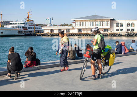 ISTANBUL, TURKEY - SEPTEMBER-14.2019: People resting on the seashore of Kadikoy coast. Stock Photo