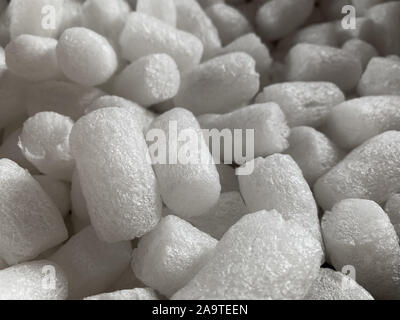 White polystyrene plastic foam elements within a parcel, to secure a safe transport. Stock Photo