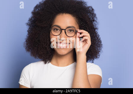 Head shot portrait smiling African American girl wearing glasses Stock Photo