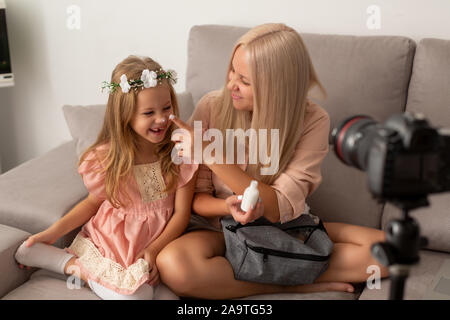 Happy loving family. Mother and daughter are doing make up and having fun Stock Photo