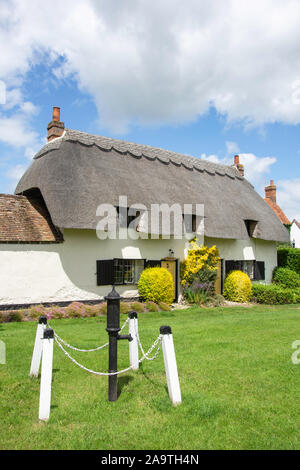 Thatched cottage on The Green, Cuddington, Buckinghamshire, England, United Kingdom Stock Photo