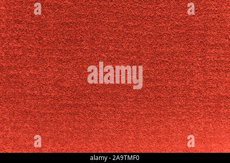 Red artificial carpet texture close-up, top view. Stock Photo