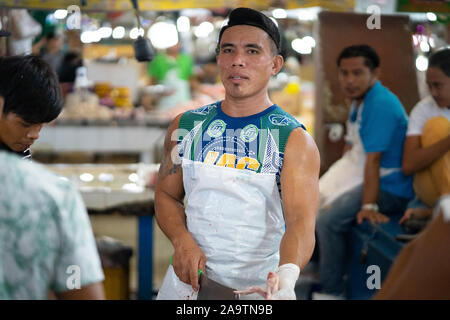 Candid Portrait of a muscular Young Filipino man working in a market,Cebu City,Philippines Stock Photo