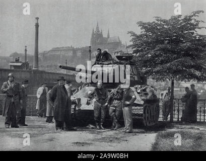 Red Army tank T-34 on the embankment of the Vltava River next to the Mánes Bridge (Mánesův most) in Prague, Czechoslovakia, in May 1945. Black and white photograph by Czech photographer Oldřich Smola taken probably on 9 May 1945 and published in the Czechoslovak book 'The Heart of Prague on Fire' ('Srdce Prahy v plamenech') issued in 1946. Courtesy of the Azoor Postcard Collection. Stock Photo