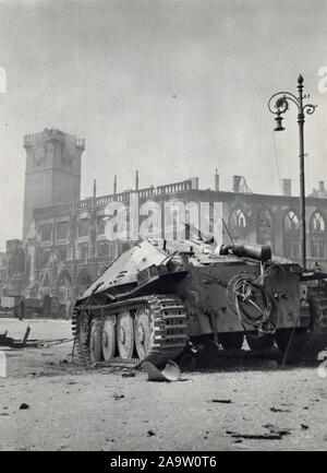 Wrecked German light tank destroyer Jagdpanzer 38 Hetzer in front of the ruins of the Old Town Hall (Staroměstská radnice) in Old Town Square (Staroměstské náměstí) in Prague, Czechoslovakia, damaged and burnt during the Prague Uprising in the last days of World War II in May 1945. Black and white photograph by Czech photographer Oldřich Smola taken probably on 9 May 1945 and published in the Czechoslovak book 'The Heart of Prague on Fire' ('Srdce Prahy v plamenech') issued in 1946. Courtesy of the Azoor Postcard Collection. Stock Photo