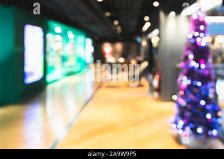 Defocused background beautiful Christmas tree and New Year decoration at lounge in modern luxury shopping mall. Blurred bokeh of decorated Christmas r Stock Photo