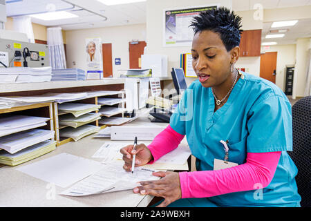 Miami Beach Florida,Mt. Mount Sinai Medical Center,hospital,healthcare,Black woman female women,nurse,technician,taking,writing information,FL10012307 Stock Photo