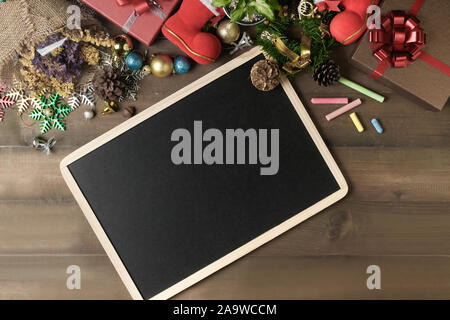 Blank black board with decorations and gift boxes, New year and Merry christmas   conceptual Stock Photo