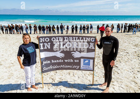 Miami Beach Florida,Surfrider Foundation,No Offshore Florida Oil Drilling Protest,Black clothing represents oil,sign,Atlantic Ocean,water,surf,FL10021 Stock Photo