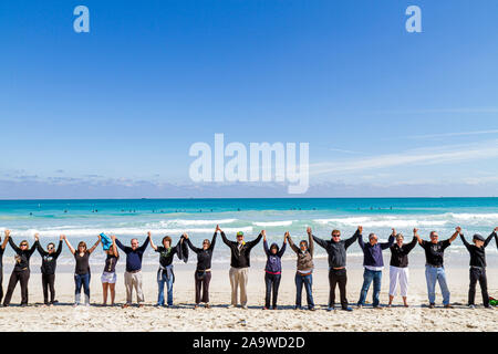 Miami Beach Florida,Surfrider Foundation,No Offshore Florida Oil Drilling Protest,Black clothing represents oil,hold hand,hands,unity,Atlantic Ocean,w Stock Photo