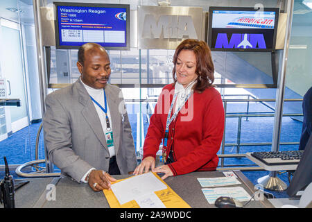 Miami Florida International Airport MIA,American Airlines,boarding gate,departure,attendant,working,work,servers employee employees worker workers job Stock Photo