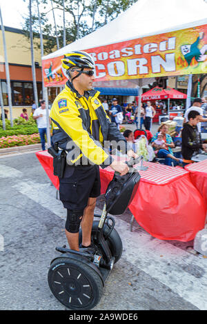 Miami Florida,Coral Gables,Carnaval on the Mile,Hispanic festival,police,policeman,personal transport,man men male,FL100307008 Stock Photo