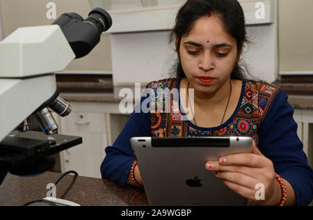 Woman using tablet in a laboratory, Concept science and Technology Stock Photo