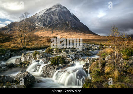 This is a long exposure of a stream and Etive Mor Waterfall  in Glencoe of the Scottish Highlands. Bauchaille mountain can be seen in the distance. Stock Photo