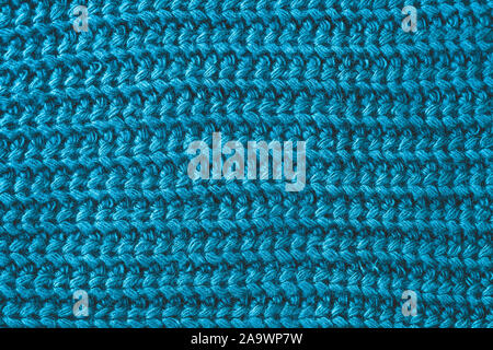 Texture of woolen knitted scarf. Yarn with knitting. Ornament of a blue knitted sweater. Abstract textile background. Stock Photo