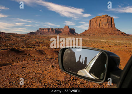 The famous Buttes of Monument Valley reflecting in car mirror