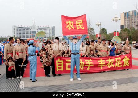 Jiangxi, Jiangxi, China. 18th Nov, 2019. Jiangxi, CHINA-November 17, 2019.Teachers, students and parents of hope star nursery in Suichuan county, Jiangxi province carried out a parent-child activity of ''military and civilian mass production'' on patriotic education theme.The event attracted more than 1,000 people from more than 600 families.Dressed in special costumes, they were divided into three groups: workers, peasants and soldiers. They played the production games such as tilling fields, carrying water, transplanting rice seedlings, threshing grains and enjoying a bumper harvest.The Stock Photo