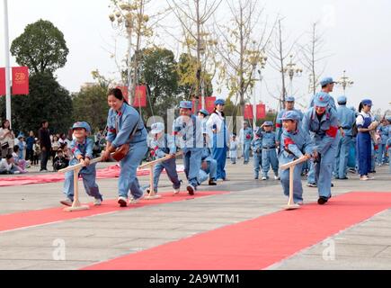 Jiangxi, Jiangxi, China. 18th Nov, 2019. Jiangxi, CHINA-November 17, 2019.Teachers, students and parents of hope star nursery in Suichuan county, Jiangxi province carried out a parent-child activity of ''military and civilian mass production'' on patriotic education theme.The event attracted more than 1,000 people from more than 600 families.Dressed in special costumes, they were divided into three groups: workers, peasants and soldiers. They played the production games such as tilling fields, carrying water, transplanting rice seedlings, threshing grains and enjoying a bumper harvest.The Stock Photo