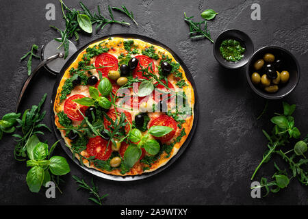 Pizza. Traditional italian pizza with green basil pesto sauce Stock Photo