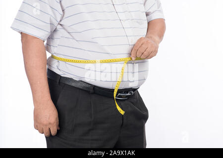 Fat mature man measuring his belly with measurement tape, isolated on white background Stock Photo