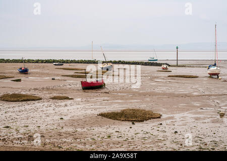 Boats in the low tide, with Morecambe Bay in the background, seen from Marine Rd in Morecambe, Lancashire, England, UK Stock Photo