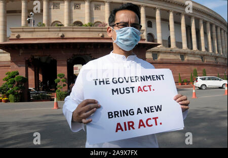 Congress Party MP Gaurav Gogoi holds placards protesting against the alarming levels of pollution in the city on the opening day of the winter session Stock Photo