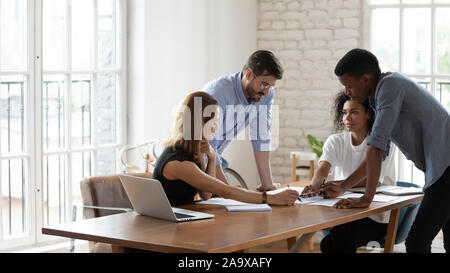 Young african american female team leader listening to multiracial colleagues. Stock Photo