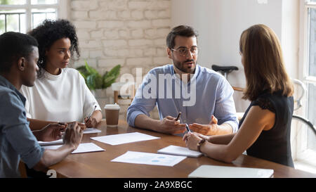 Concentrated employees listening to boss project instruction. Stock Photo