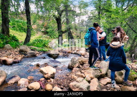 Rural area of Khizana, Chefchaouen, Morocco - April 29, 2018: A group of hikers in the rural area of Khizana, near Chefchaouen, Morocco. Stock Photo