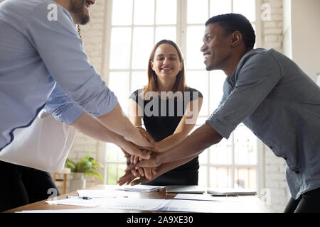Leader motivating young mixed race colleagues before starting new project. Stock Photo