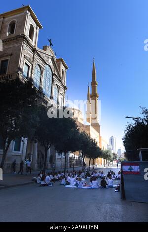 *** STRICTLY NO SALES TO FRENCH MEDIA OR PUBLISHERS *** November 17, 2019 - Beirut, Lebanon: A group of Lebanese protesters hold a meditation class in the street near Martyrs' Square, quietly practicing breathing exercices as their leader repeats the mantra 'Love, kindness, peace'. The meditation took place in the morning of a mass rally celebrating the one month-anniversary of the beginning of the Lebanese revolution. Un groupe de manifestants libanais pratiquent la meditation dans la rue pres de la Place des Martyrs, quelques heures avant une grande manifestation pour marquer les 1 mois du s Stock Photo