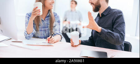 young employees discussing something during the coffee break. Stock Photo