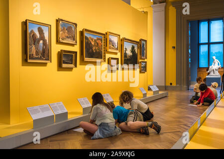 Art gallery children, view of schoolchildren copying 19th century landscape paintings in the Swedish Nationalmuseum, Stockholm. Stock Photo