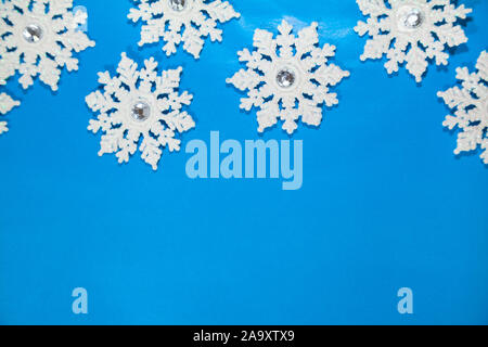 White snowflakes on a blue background. Christmas decor. Stock Photo