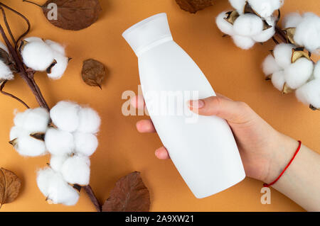 A jar of shampoo on a orange background. Layout for your label. Stock Photo