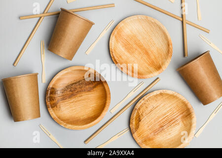 Paper plates, cups and sticks on a gray background Stock Photo