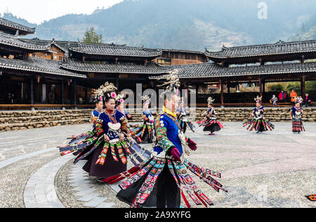 The Chinese miao women wearing traditional clothes and dancing in open opera house of Xijiang Qianhu Miao Village (The One Thousand Household Miao Vil Stock Photo