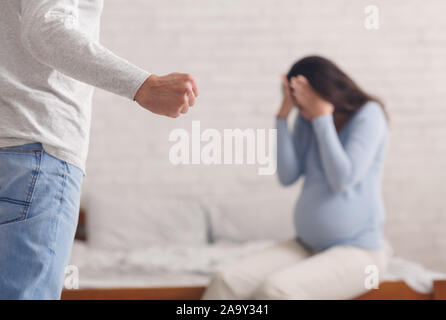 Pregnant woman suffering from domestic abuse from husband Stock Photo