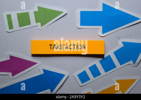 Take Action text on sticky notes isolated on office desk Stock Photo