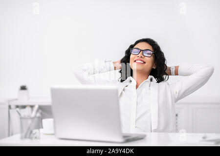 Young businesswoman in formalwear relaxing at workplace Stock Photo