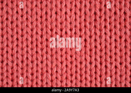 Stockings with spokes. Fragment of red knitted pullover handmade background. Knitting things favorite hobby. Stock Photo