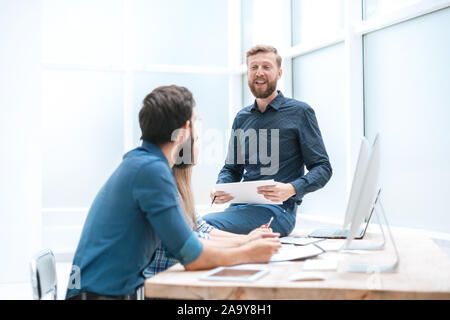 business team is discussing something at the workplace in the office Stock Photo