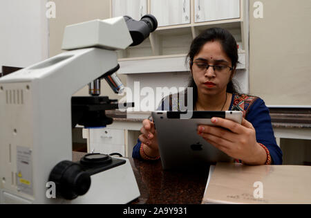 Woman using tablet in a laboratory, Concept science and Technology Stock Photo